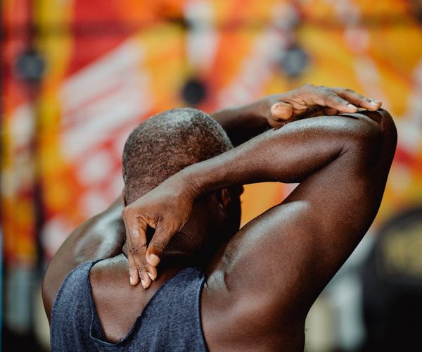 Man stretching arm with focus and calm